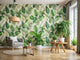 Eco-friendly wallpaper rolls with green leaf motifs surrounded by potted plants in a modern room to highlight sustainability.