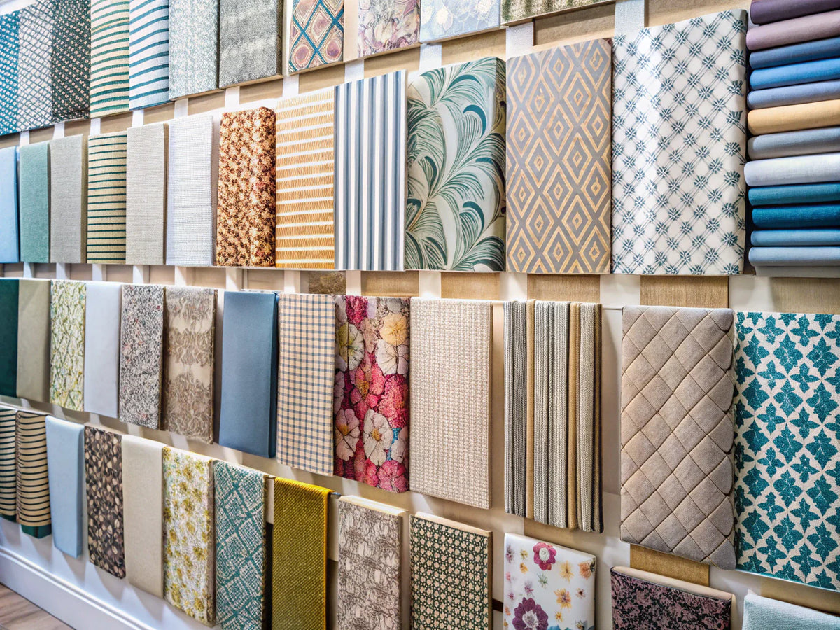 A display of various wallpaper sample swatches in different patterns and colors, highlighting their importance in home design selection.